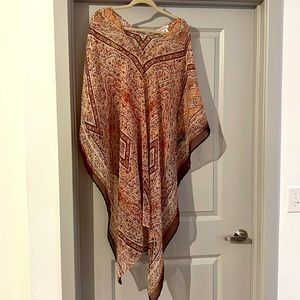 Sheer, patterned poncho! Worn as a top or a cover up.